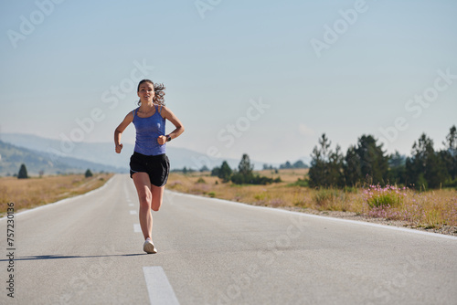 A determined woman athlete trains for success in the morning sun.