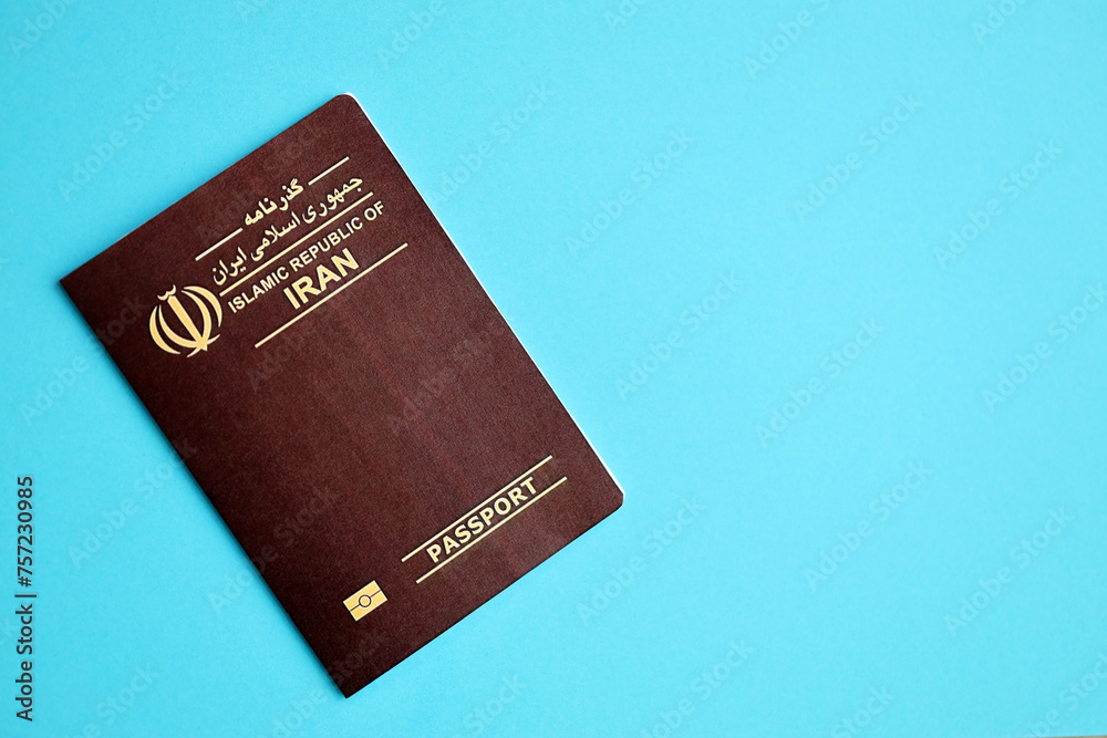 Red Islamic Republic of Iran passport on blue background close up. Tourism and citizenship concept Red Islamic Republic of Iran passport on blue background close up. Tourism and citizenship concept