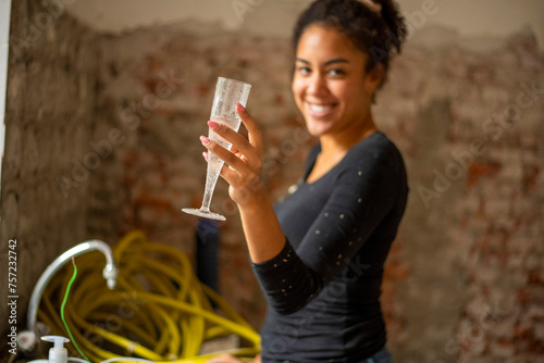Young woman enjoying a celebratory toast at a casual gathering photo