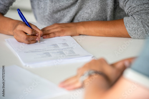 Person filling out a form with assistance