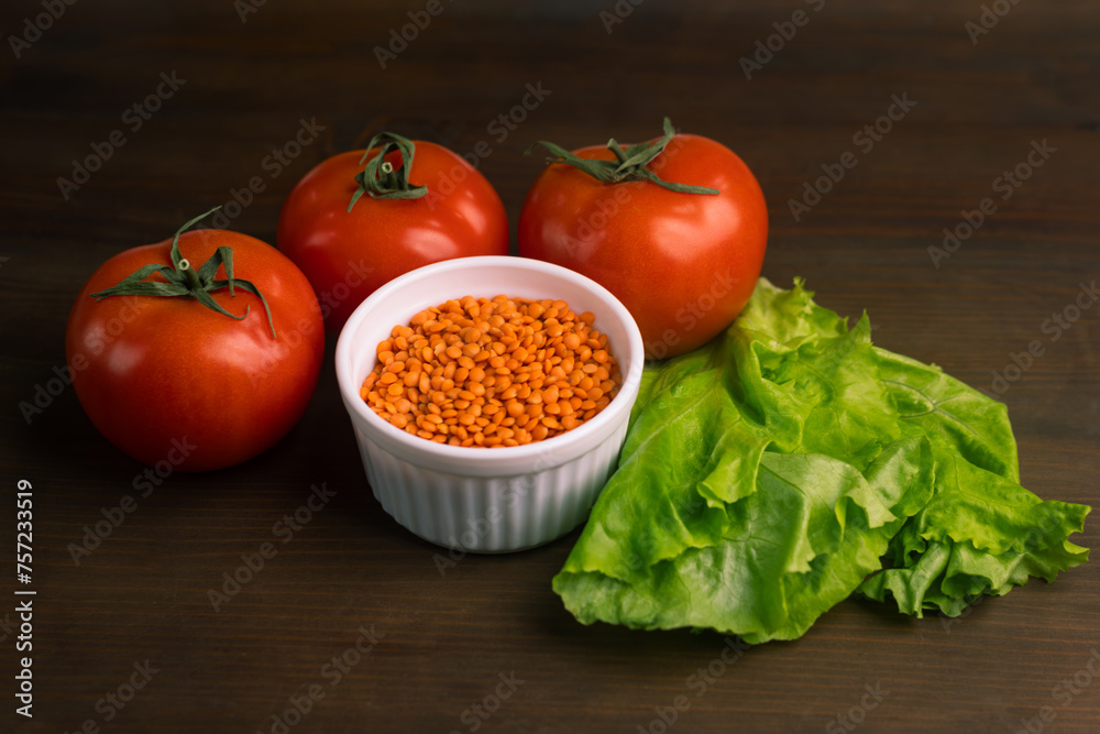 Tomatoes lentils green salad on brown background Tomatoes lentils green salad on brown background