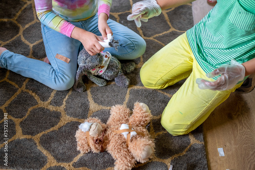 Children playing veterinarian with stuffed animals photo