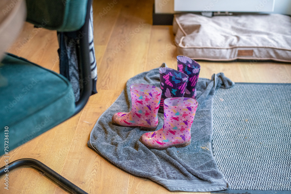 Pink children's boots on a towel indoors Pink children's boots on a towel indoors