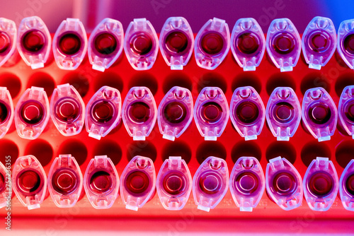 Rows of vividly colored test tubes in a lab