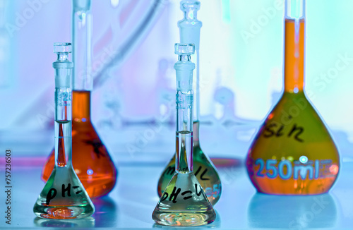 Colorful chemistry glassware illuminated in a science lab photo