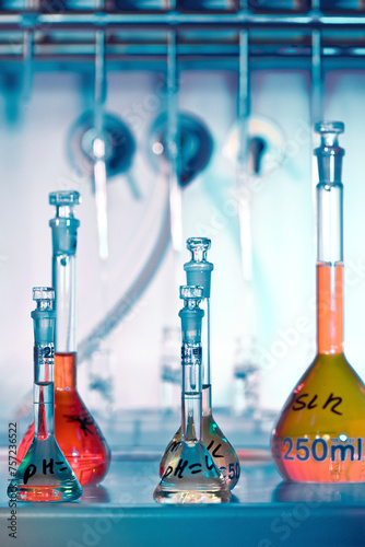 Colorful chemistry glassware arranged on a lab bench photo