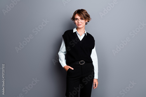 Photo of positive happy lady professor dressed black vest eyewear empty space isolated grey color background