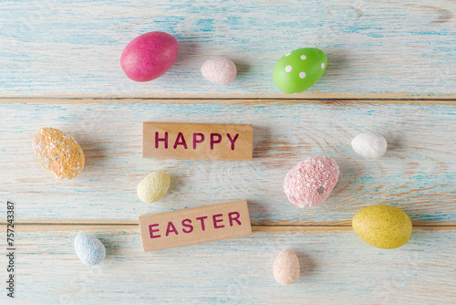 Festive Easter: Colorful Eggs and Wooden Blocks with words Happy Easter