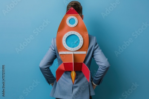 Businessman with rocket on his back, business and startup concept.