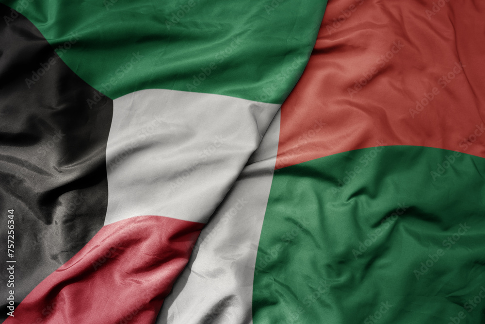 big waving national colorful flag of madagascar and national flag of kuwait.