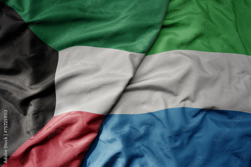 big waving national colorful flag of sierra leone and national flag of kuwait.