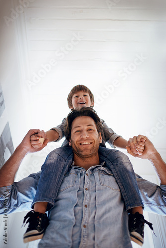 Portrait, carry and son on shoulders of father in home from below for bonding, fun or relationship. Family, smile or happy with man parent and boy kid in apartment together for development or growth