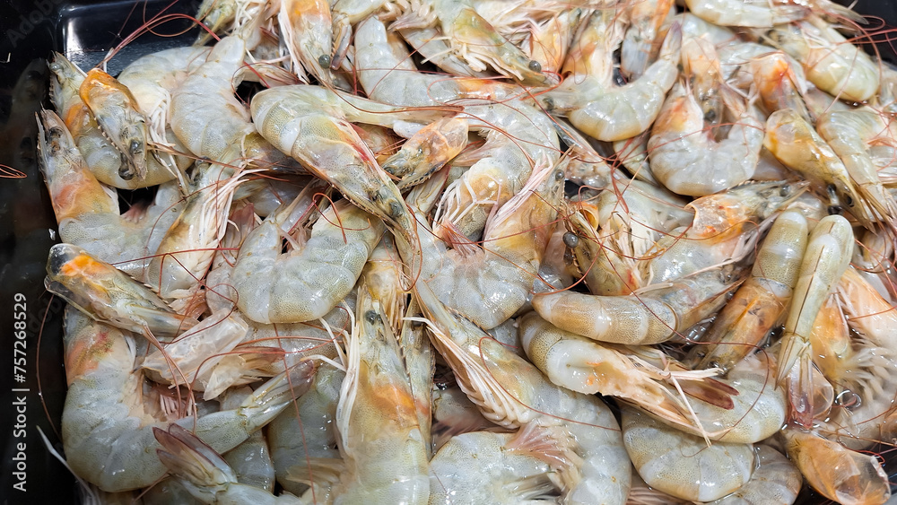 Fresh raw shrimp or prawn for selling in a plate in a fish market in Banjar City, Indonesia.