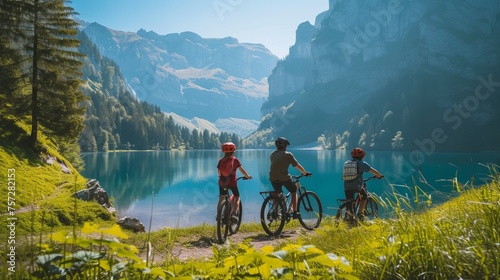 A family of three enjoying a serene and picturesque view with mountains and lake, pausing for a break during their journey by bicycles