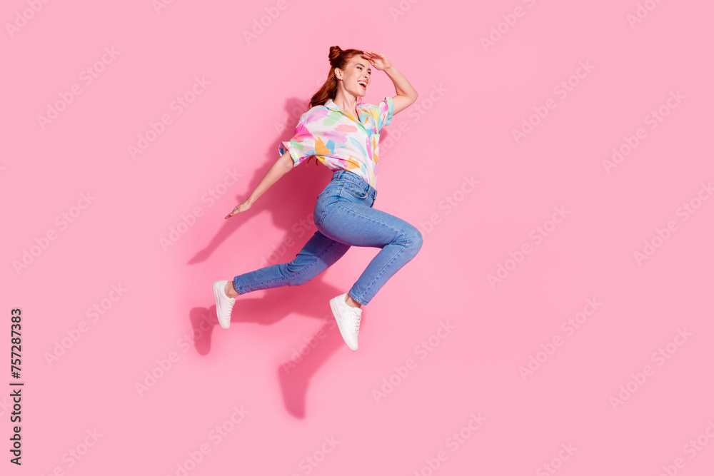 Full body size photo of red hair charming woman young age jump running touch forehead far away looking isolated on pink color background