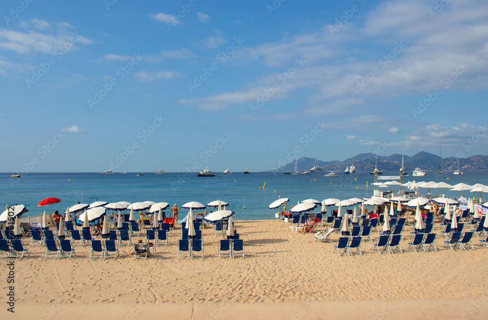 A beach on La Croisette in Cannes in the south of France, with deckchairs, umbrellas and jetty. A beach on La Croisette in Cannes in the south of France, with deckchairs, umbrellas and jetty.