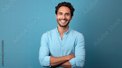 Handsome young man smiling while standing against blue background ©  Mohammad Xte