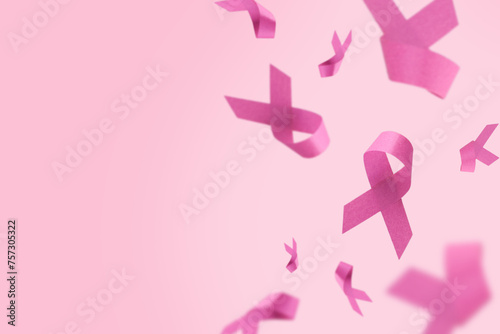 Pink Breast Cancer Awareness Ribbon. Flying pink ribbons on pink background. Breast cancer awareness and October Pink day, world cancer day. Top view. Mock up.
