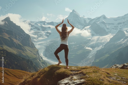 Healthy woman is practicing yoga on the mountains