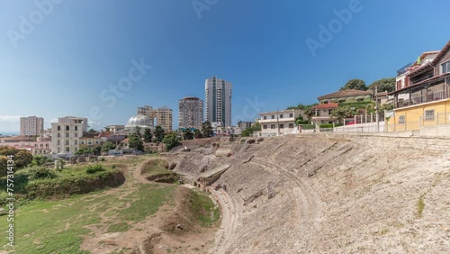 Panorama showing the Amphitheatre of Durres (Amphitheatrum Dyrrhachium) timelapse from above. Ruins of the ancient Roman amphitheatre in the center of Durres, Albania. photo