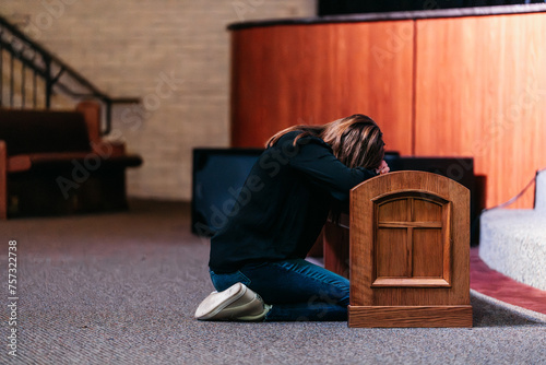 Person kneeling down at alter, Woman praying in church