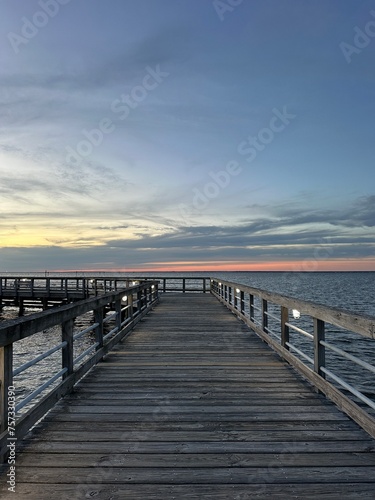 Fototapeta Naklejka Na Ścianę i Meble -  Sandestin Florida walking pier with sunset sky background 
