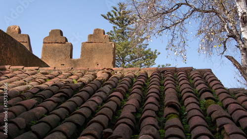 Tile roof below a parapet wall in the Kasbah, in the Uta Hammam Square, in Chefchaouen, Morocco © Angela