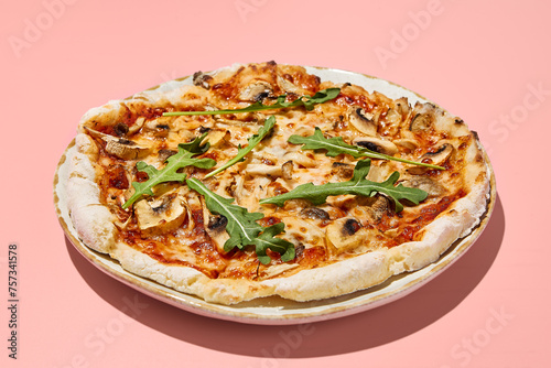 Gluten-free pizza with mushrooms and tomatoes on a stylish plate with a pink backdrop