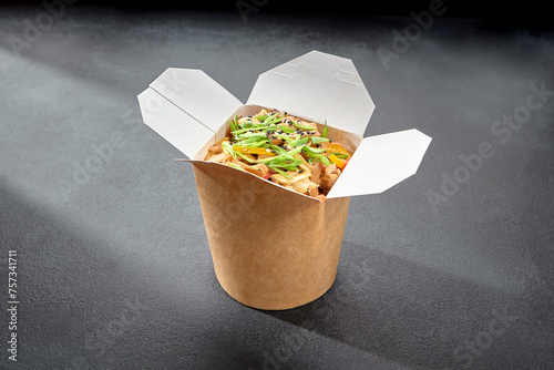 Soba noodles with chicken in a creamy sauce, served in a takeaway box for a convenient and flavorful meal on the go
