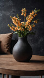 Clay vase with flowers on a round wood table, sofa against black concrete wall in a modern Scandinavian living room.
