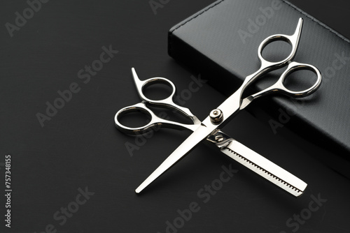 Canvas Print Hairdressing scissors with case on a black background