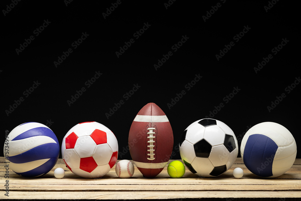 Set of various sport balls on wooden floor on black background Set of various sport balls on wooden floor on black background