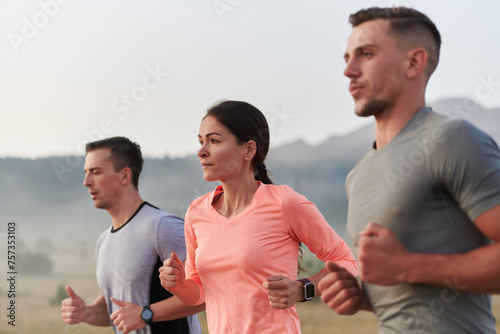 Tableau sur toile A group of friends, athletes, and joggers embrace the early morning hours as the