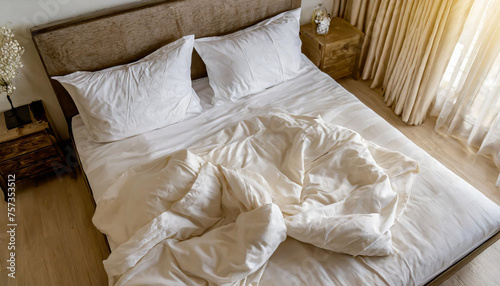 Top view of unmade bedding sheets and pillow ,Unmade messy bed after comfortable sleep concept