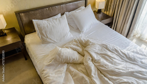 Top view of unmade bedding sheets and pillow ,Unmade messy bed after comfortable sleep concept