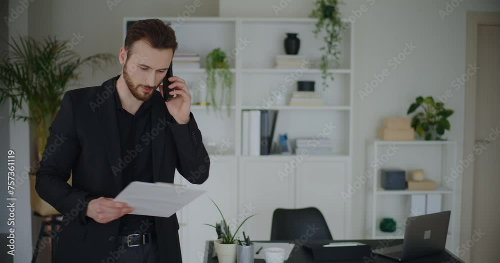 Confident male entrepreneur holding clipboard discussing strategy on call