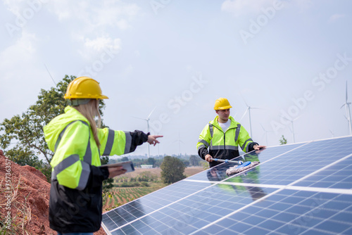 Wallpaper Mural Engineers working inspect and check solar cell panel energy is smart grid ecology energy sunlight alternative power with wind turbine farms rotation to generate electricity. Torontodigital.ca