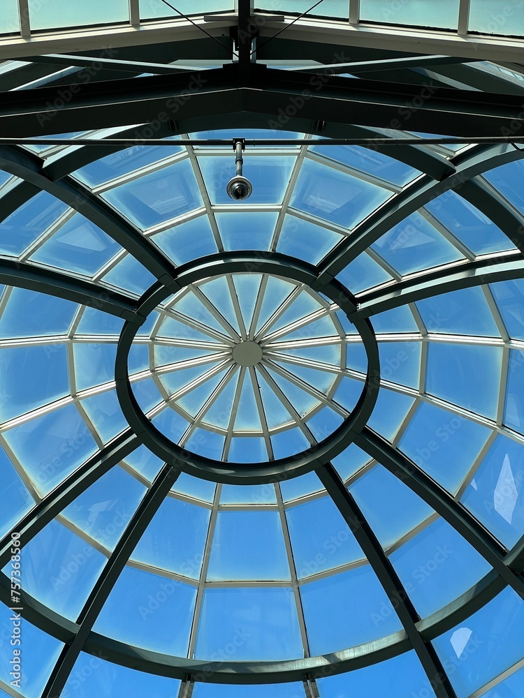 Abstract glass ceiling against a blue sky