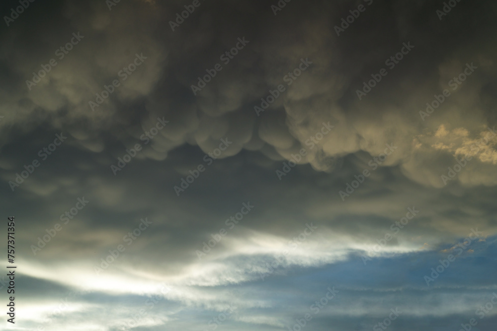 Close up view of beautiful colored dramatic cumulus fluffy clouds on blue sky at sunset background
