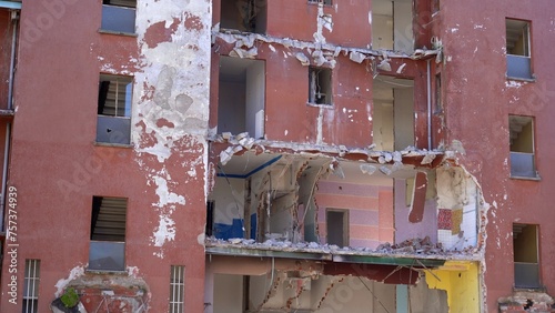 Italy, Milan 03-13-2024 gru carne demolition of public buildings and urban redevelopment project of the  suburbs - demolish a degraded building in a state of abandonment - Giambellino Lorenteggio  photo