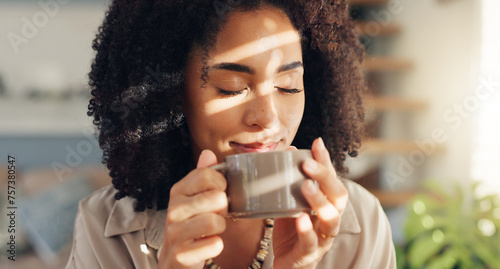 Smile, calm and woman with coffee by window in apartment for relaxing weekend morning routine. Happy, peace and young female person drinking cappuccino, tea or latte in cup with aroma at modern home.