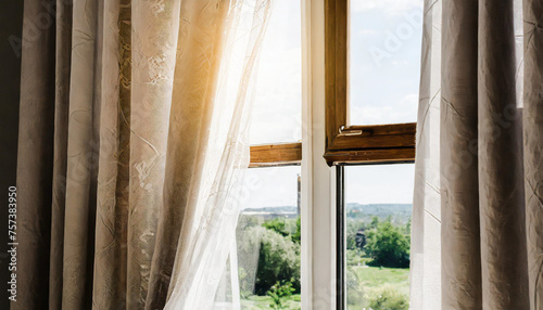 Sun shines in open window, blowing wind moves curtain. © netsay