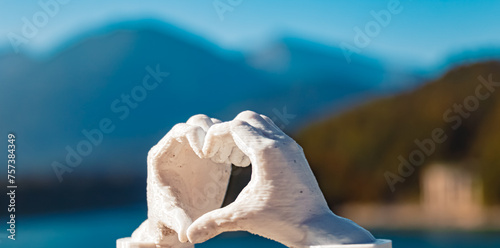 Heart hands gesture with a 3D printed sculpture - free model from thingiverse - at reservoir Lake Sylvenstein, Lenggries, Bad Toelz-Wolfratshausen, Bavaria, Germany photo