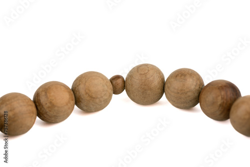 Close-up on grains of wooden prayer rosary isolated on white background.