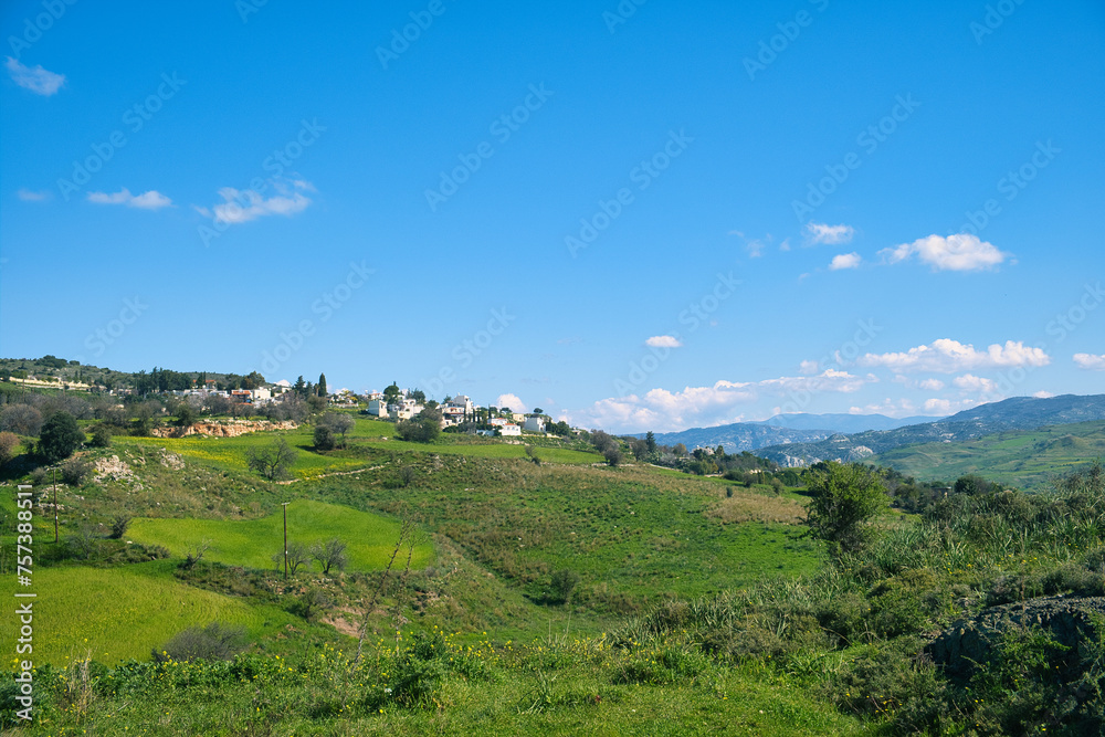 Landscape with green fields, mountains and a village near Nata, district of Paphos (Pafos), Cyprus, on a sunny day
