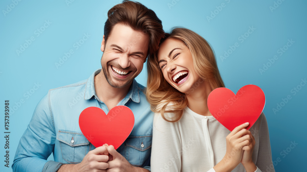 Happy couple holding red hearts celebrating valentine's day Happy couple holding red hearts celebrating valentine's day