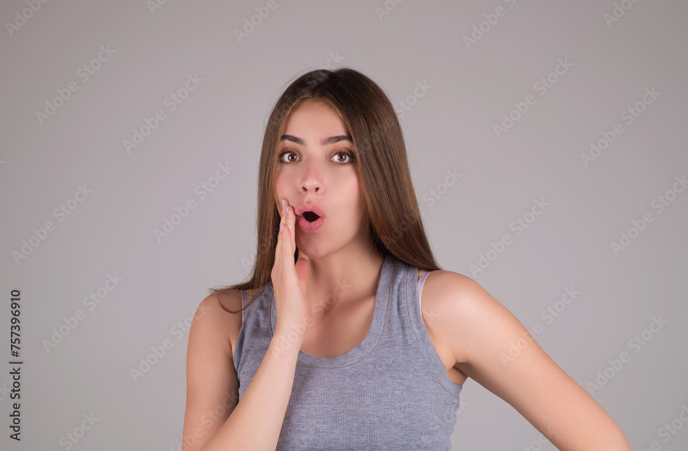Shocked face of woman shouting WOW, isolated on studio background with copy space. Shock content. Girl looks with terrified expression, shocking news. Woman shocked face with open mouth and big eyes. Shocked face of woman shouting WOW, isolated on studio background with copy space. Shock content. Girl looks with terrified expression, shocking news. Woman shocked face with open mouth and big eyes.