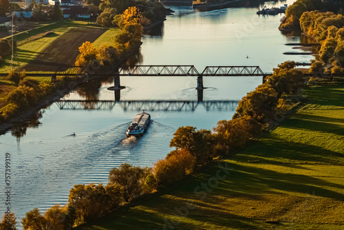 Autumn or indian summer view with reflections and a cargo ship at Mount Bogenberg, Bogen, Danube, Bavaria, Germany photo