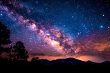 Stunning Night Vista: Milky Way Galaxy Brilliance Over Mountain Silhouettes.