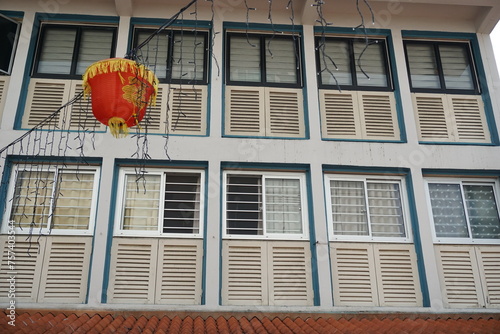 Wooden Louvered Windows of Old Shophouses and Red Lantern in Toa Payoh Central, Singapore photo